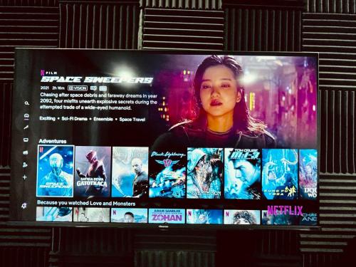 a television screen with a picture of a movie at Cozy Villa - Private Pool, 5BR, KTV, BBQ, PS5 just 3 Mins to Batu Ferringhi Beach! in Batu Ferringhi