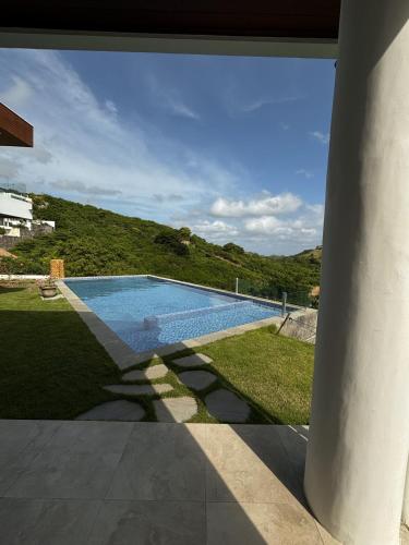 a swimming pool with a hill in the background at Villa Ayu Lombok in Kuta Lombok