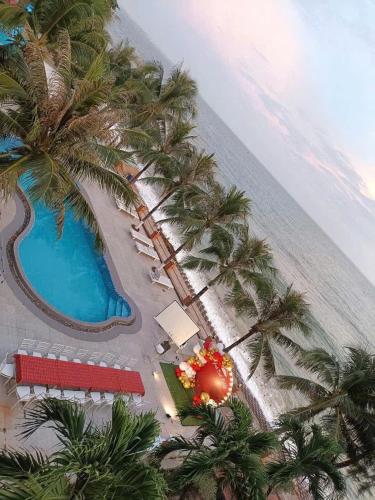 an aerial view of a resort with a pool and palm trees at HAVANA Beach & Pool Villa - Mui Ne,Phan Thiet in Mui Ne
