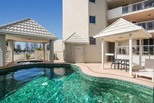a swimming pool in the backyard of a house at Point View at The Sandcastles Resort Mooloolaba in Mooloolaba