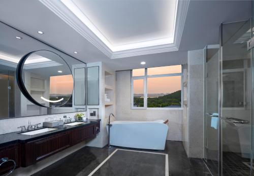 a bathroom with a large tub and a large window at Holiday Inn Xuzhou Yunquan by IHG in Xuzhou