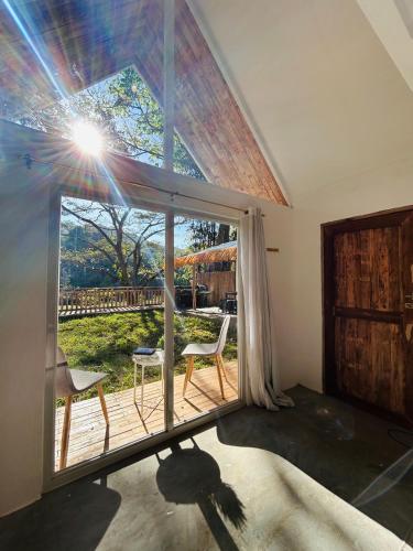 a room with a large window and two chairs at Private Mountain River Cabin in Daraitan Tanay Rizal Philippines in Tanay