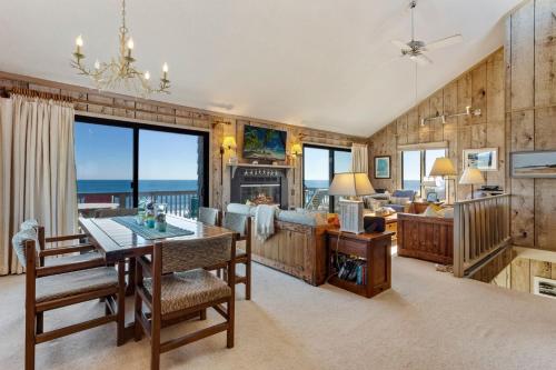 a dining room and living room with a view of the ocean at 5135 - The Anchor in Croatan Shores