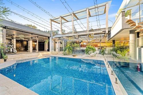 a swimming pool in the middle of a house at Luxury 6beds Waterfront Retreat in Sydney