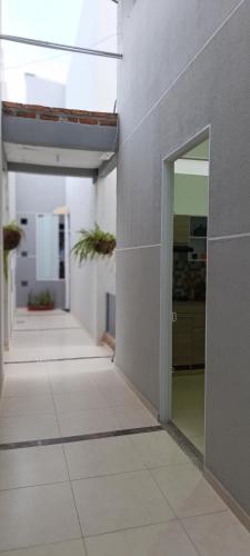 a hallway of a building with an open door at Alojamientos ejecutivos y modernos en condominio privado in Aguachica