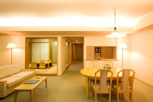 a living room with a couch and a table at Izumigo AMBIENT Tateshina Hotel in Tateshina