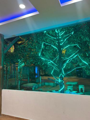 a wall with a tree painted on it at Maju Farm House in Hulu Langat