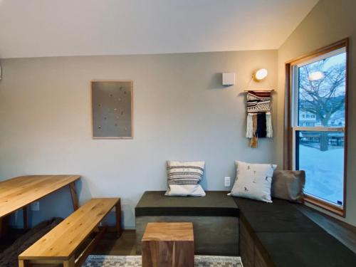 a living room with a bench and a window at The Lake Side Inn in Shinano