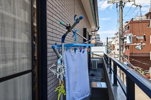 a view of a balcony with a curtain andabling at HOSTEL198 in Osaka