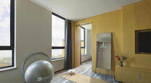a living room with a large room with windows at Xian Elegant Oriental Hotel in Xi'an