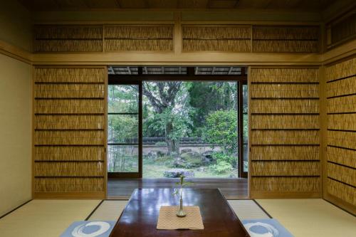 a room with a table and a large window at Villa璃都りーと Villa Retreat in Ibaraki