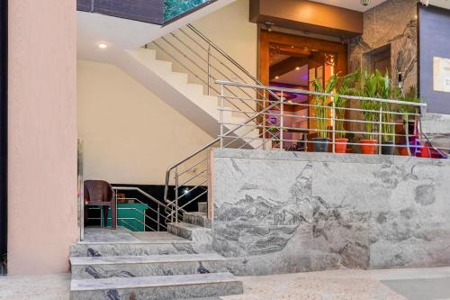 a staircase in a house with a painting on the wall at Hotel O XOTEL Near HSR in Bengaluru