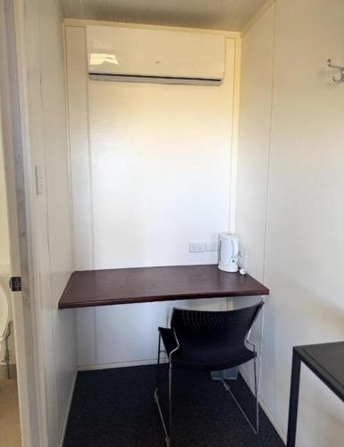 a desk in the corner of a room with a chair at Piangil Cabin and Accomodation in Piangil