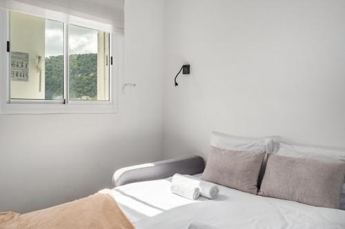 a bedroom with a white bed with a window at Pool & Jacuzzi Seaview Penthouse by Sea N' Rent in Haifa