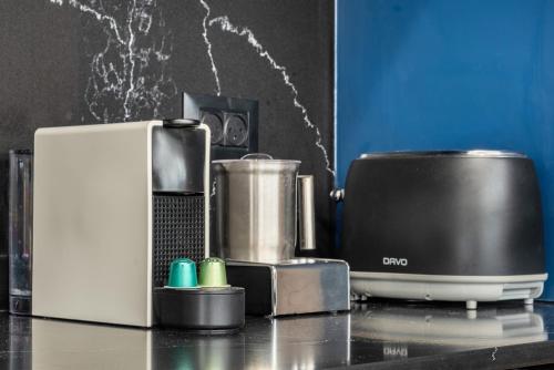 a kitchen counter with a coffee maker and a blender at Pool & Jacuzzi Seaview Penthouse by Sea N' Rent in Haifa