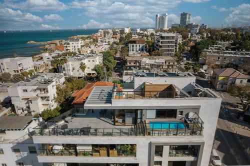 an apartment building with a view of the ocean at Pool & Jacuzzi Seaview Penthouse by Sea N' Rent in Haifa