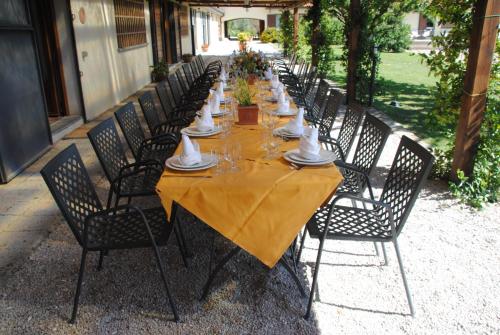 a long table with chairs and plates on it at Agriturismo Valle Siriaca in Castelnuovo di Porto