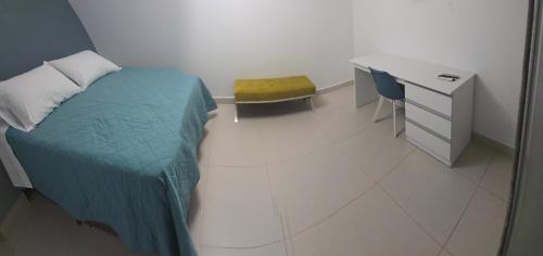 a bedroom with a bed and a desk and a chair at LAS GAVIOTAS DE PARACAS in Paracas