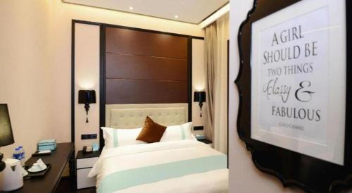 a hotel room with a bed and a large mirror at Xana Hotelle Xi'an Zhonglou, Huimin Street Metro Station in Xi'an