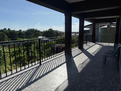 a balcony with a chair and a view of the ocean at Lonely Hill Apartment in Honiara