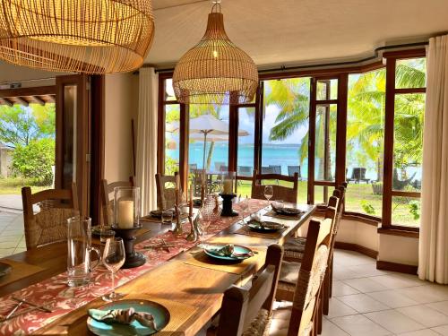 a dining room with a table with a view of the ocean at Villa Nacéli - Seaside Villa in Belle Mare in Post of Flacq