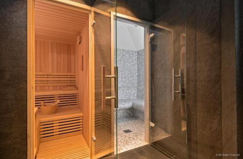 a glass shower stall with a toilet in a bathroom at Priska Med Luxury Rooms in Split