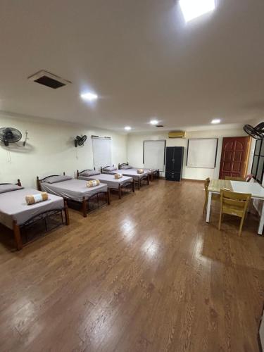 a room with a bunch of beds in it at Maju Farm House in Hulu Langat