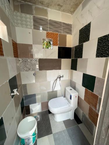 a bathroom with a toilet and a sink at Maju Farm House in Hulu Langat