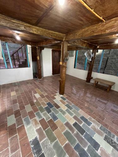 a room with a stone floor and a wooden ceiling at Maju Farm House in Hulu Langat