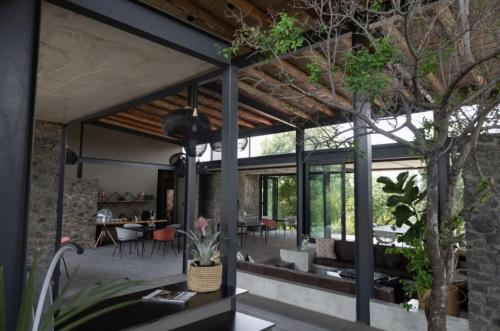 a house with a large patio with tables and chairs at Umoya Safari Lodge in Matlhagame