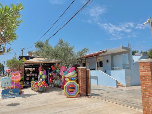 a store with a bunch of colorful merchandise in a parking lot at Stela Apartments in Ksamil