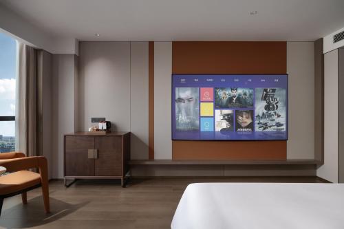 Un ou plusieurs lits dans un hébergement de l'établissement New Century Mansion Hotel Tongxiang Puyuan International Trade Center