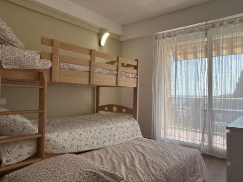 une chambre avec deux lits superposés et une fenêtre dans l'établissement T3 moderne avec climatisation et parking, à 200m de la plage - FR-1-225C-177, à Banyuls-sur-Mer