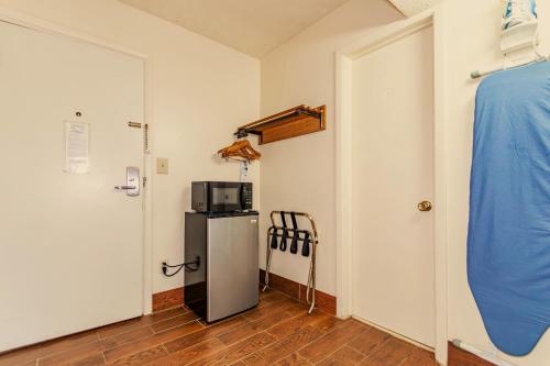 a room with a refrigerator and a microwave on a wall at Americas Best Value Inn Ashtabula/Austinburg in Austinburg