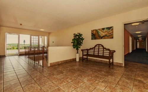 a living room with a couch and a plant on the wall at Americas Best Value Inn Ashtabula/Austinburg in Austinburg
