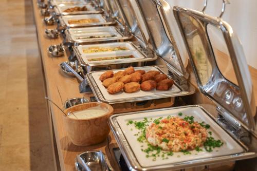 a buffet line with a row of trays of food at La Boheme - Adults Only in Obzor