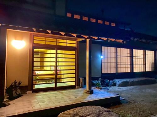 a door of a house with a night time at Villa璃都りーと Villa Retreat in Ibaraki