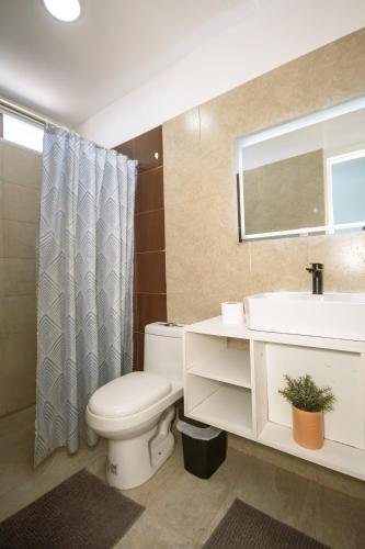 a bathroom with a toilet and a sink and a mirror at Suite Studio Manta in Manta