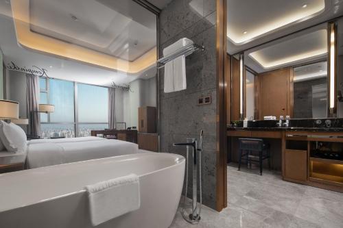 a bathroom with a large white tub in a room at Kempinski Hotel Changsha in Changsha