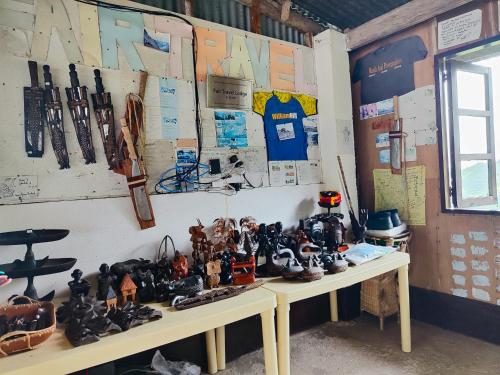 a room with a table with a bunch of figurines on it at BATAD Simons Viewpoint Inn and Pizza Restaurant in Banaue