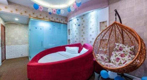 a bedroom with a red chair and a bed at Zhaoxiangju Boutique Hotel Changshui Branch in Kunming
