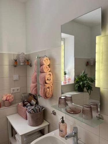 a bathroom with a sink and a mirror at Ferienwohnungen Auszeit in Chemnitz