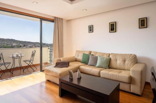 a living room with a couch and a table at Lobos Horizon by An Island Apart in Câmara de Lobos
