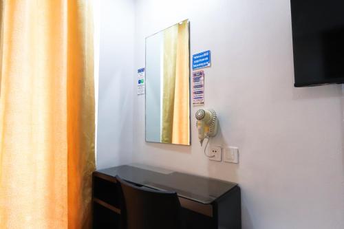 a room with a table and a mirror on a wall at Hotel Dreamworld North Edsa in Manila