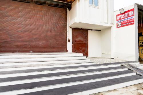 a set of stairs in front of a building with a door at Hotel O Stay Inn in Patna