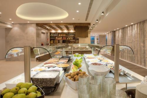 a buffet line of food in a restaurant at Caravia Beach Hotel in Marmari