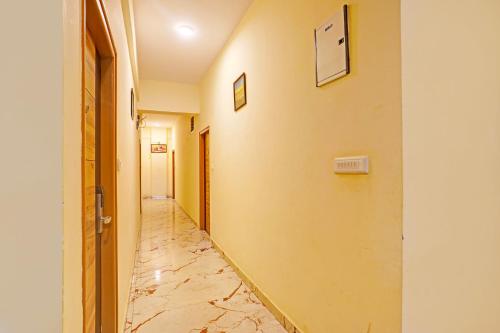 a hallway with a tile floor and a wall at FabExpress Kings Palace Manyata in Bengaluru
