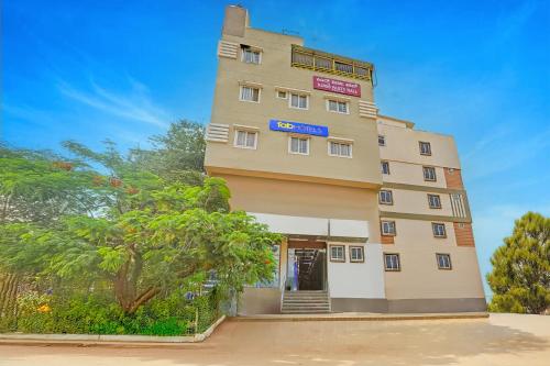 a tall building with a sign on it at FabExpress Kings Palace Manyata in Bengaluru