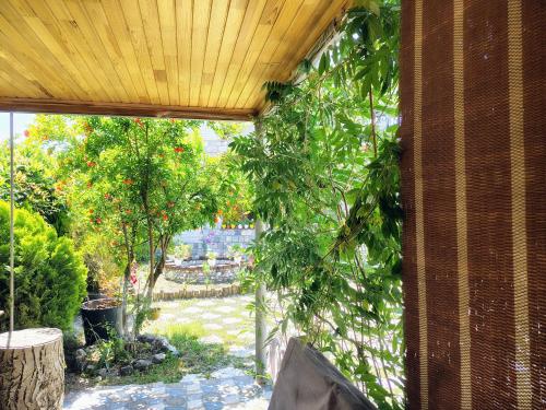 an outside view of a garden with trees at NarInn Guesthouse in İsmayıllı