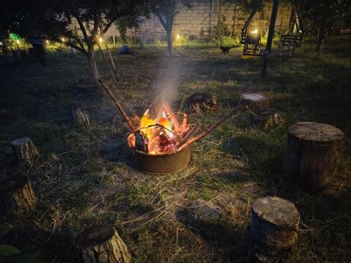 a fire in a pot in a yard at night at NarInn Guesthouse in İsmayıllı